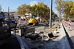 Straßenbaustelle mit Absperrpfosten und Bäumen im Hintergrund