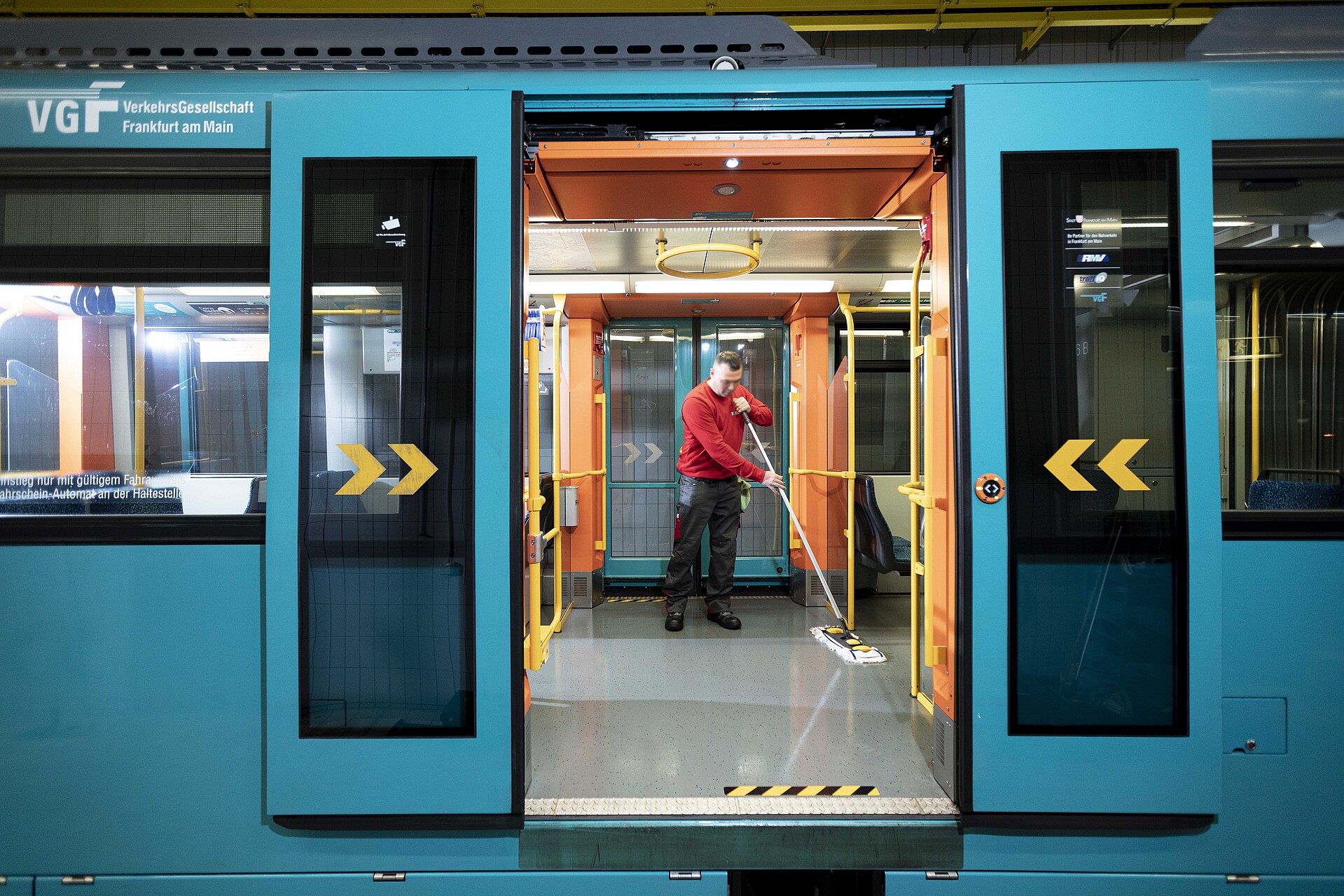 Reinigung Straßenbahn Das Bild zeigt eine reinigende Person in einer Straßenbahn der VGF.