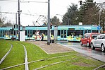 VGF-U-Bahn neben einer Wiese und parkenden Autos